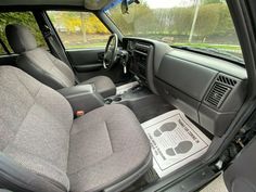 the interior of a vehicle with grey seats