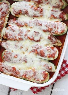 stuffed zucchini boats with sauce and cheese in a casserole dish