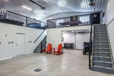 an empty garage with red chairs and stairs