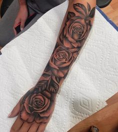 a woman's arm with roses on it