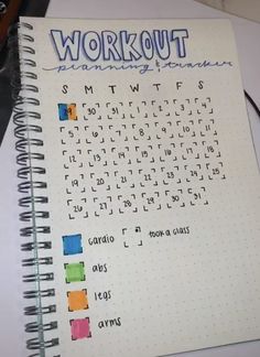 a notebook with the words workout written in different colors and shapes on top of it