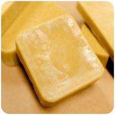 two pieces of yellow soap sitting on top of each other