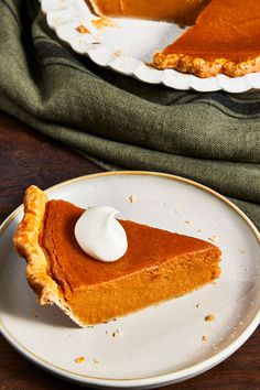 a slice of pumpkin pie on a white plate