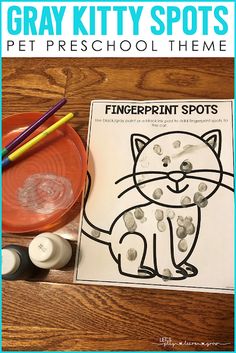 the gray kitty spots pet preschool theme is displayed on a table with markers and pencils