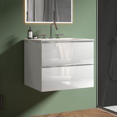 a bathroom with green walls and a white sink