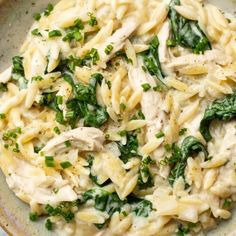 pasta with chicken and spinach in a bowl