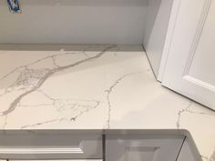 a kitchen counter with white marble on it