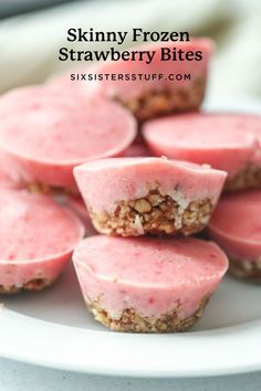 some pink desserts are on a white plate