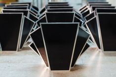 several black vases sitting on top of a table