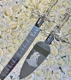 two wedding cake servers with the bride and groom's names engraved on them