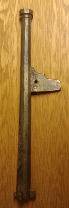 an old metal door handle on a wooden door