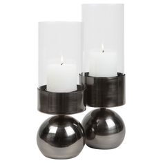 two silver candles sitting on top of each other