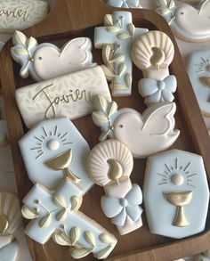 some cookies that are sitting on a wooden tray with name written on them and other cookie decorations