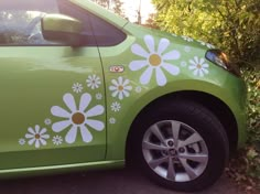 a green car with white flowers painted on it