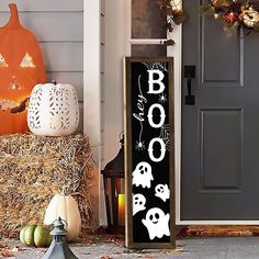 a halloween porch decoration with pumpkins and decorations