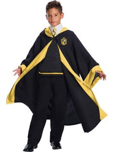 a young boy dressed up in a harry potter costume with his hands on his hips