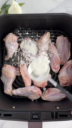 raw chicken being cooked in an air fryer