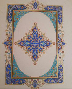 an ornate blue and gold design on the wall in a room with white walls,