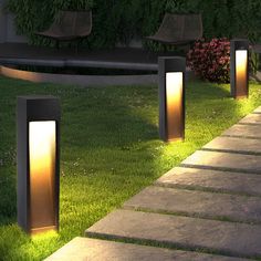 some lights that are sitting in the grass next to each other on concrete steps and benches