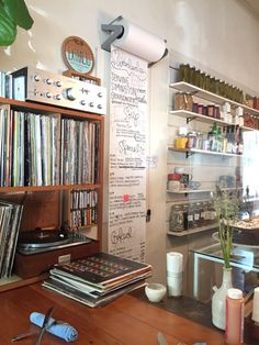 an old record player is sitting on the table in front of some records and cds