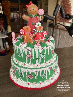 a large christmas cake decorated with gingerbread bears and candy canes