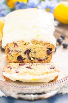 a loaf of lemon blueberry bread sitting on top of a glass plate