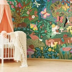 a baby's crib in front of a colorful wall mural with animals and trees