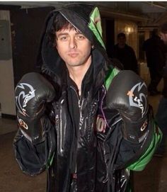 a man wearing boxing gloves and a hoodie