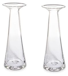 two clear glass vases sitting side by side on a white background, one has a round top and the other has a curved bottom