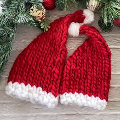 "Order early! Shipping carrier/transit delays are expected this holiday season. No guarantee on delivery date and NO REFUNDS for a late delivery. Each order has two timelines: 1. production (your ship-by date), 2. shipping/transit. This listing is for one knitted Santa hat with your choice of hat color and size. The hat comes in two sizes (Adult and Kid) and in two colors (Red and Maroon). The maroon color is a darker red. The adult size is approximately 20\" tall and 9.5\" wide at its widest po Knit Santa Hat, Christmas Party Hat, Santa Christmas Party, Knitted Santa, Baby Santa Hat, Knitted Stocking, Christmas Party Hats, Baby Santa, Holiday Hats