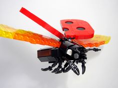 a lego insect with red and yellow wings