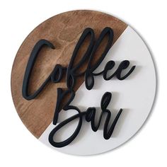 a sign that says coffee bar on top of a white plate next to a wooden board