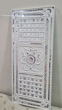 an ornate white door is hanging on the wall