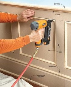 a man using a power drill to attach a wall panel