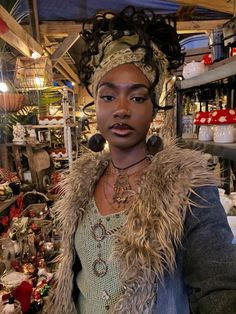 a woman in a shop with lots of christmas ornaments on the shelves and around her head