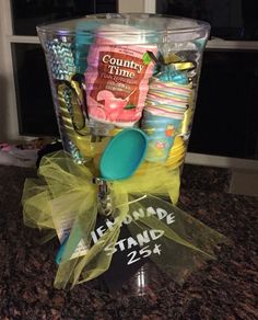 a counter top with a cup and some items in it on the counter next to a window