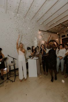 the bride and groom are surrounded by confetti