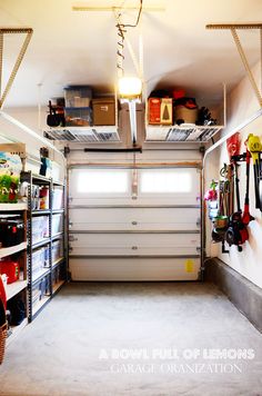 the inside of a garage with several shelves and tools on it's sides, including an overhead storage unit