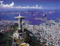 an aerial view of the city and statue of christ on top of a hill in rio