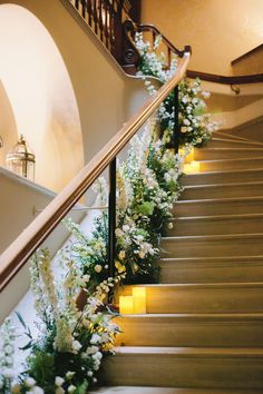 some flowers and candles are on the stairs