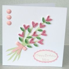 a handmade birthday card with pink flowers and green leaves on the front, says happy birthday mom