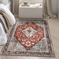 a bedroom with a large rug on the floor in front of a bed and window