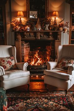 two white chairs sitting in front of a fire place next to a rug on the floor