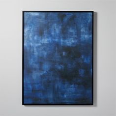 an abstract blue painting hangs on the wall