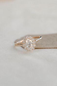 a diamond ring sitting on top of a piece of cloth