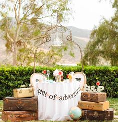 a table with several pieces of luggage and a sign that says city of abra