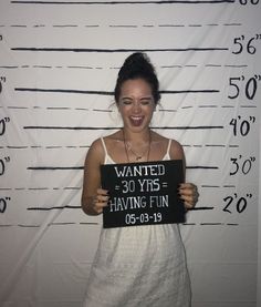 a woman holding a sign that says wanted 30 yrs having fun