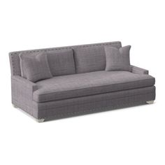 a gray couch sitting on top of a white floor