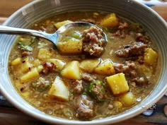 a bowl of soup with meat and potatoes