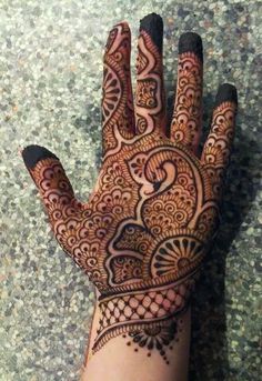 the hand is decorated with henna designs